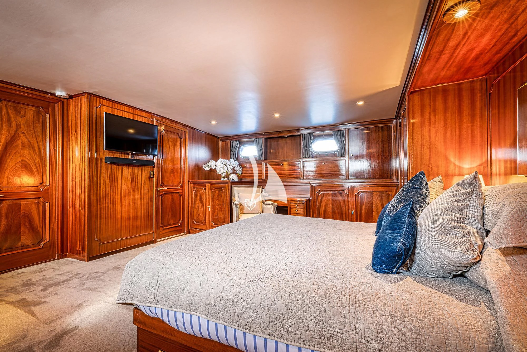 a bedroom with a bed and a television aboard CHANTELLA Yacht for Sale