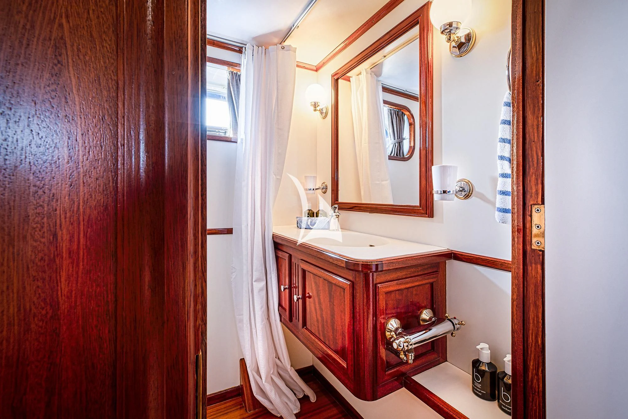a bathroom with a sink and mirror aboard CHANTELLA Yacht for Sale