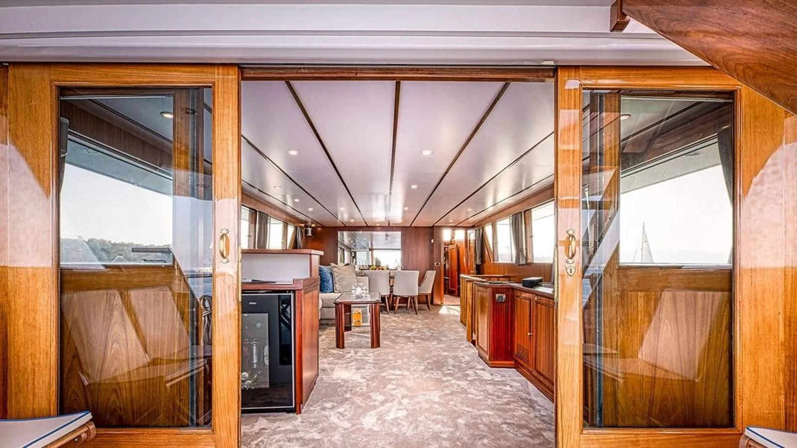 a room with a fireplace and a large window aboard CHANTELLA Yacht for Sale
