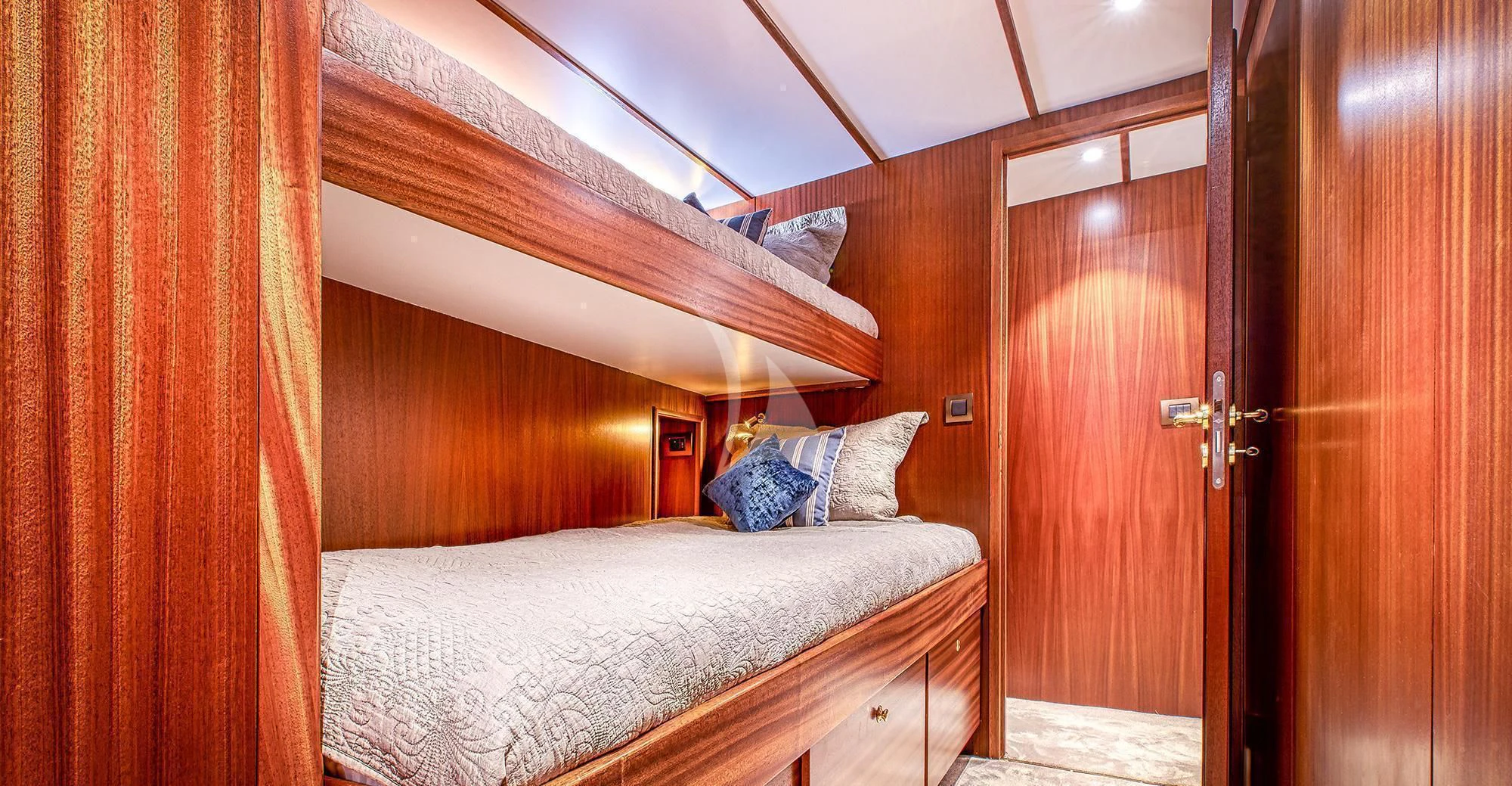 a bedroom with a bed and a wood door aboard CHANTELLA Yacht for Sale