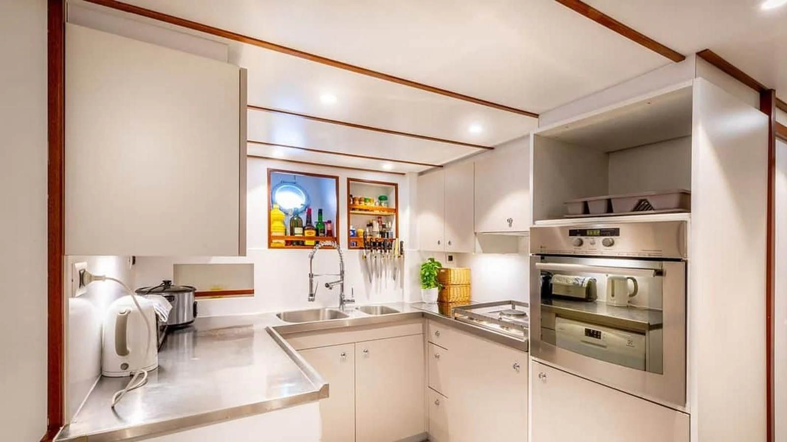 a kitchen with white cabinets aboard CHANTELLA Yacht for Sale