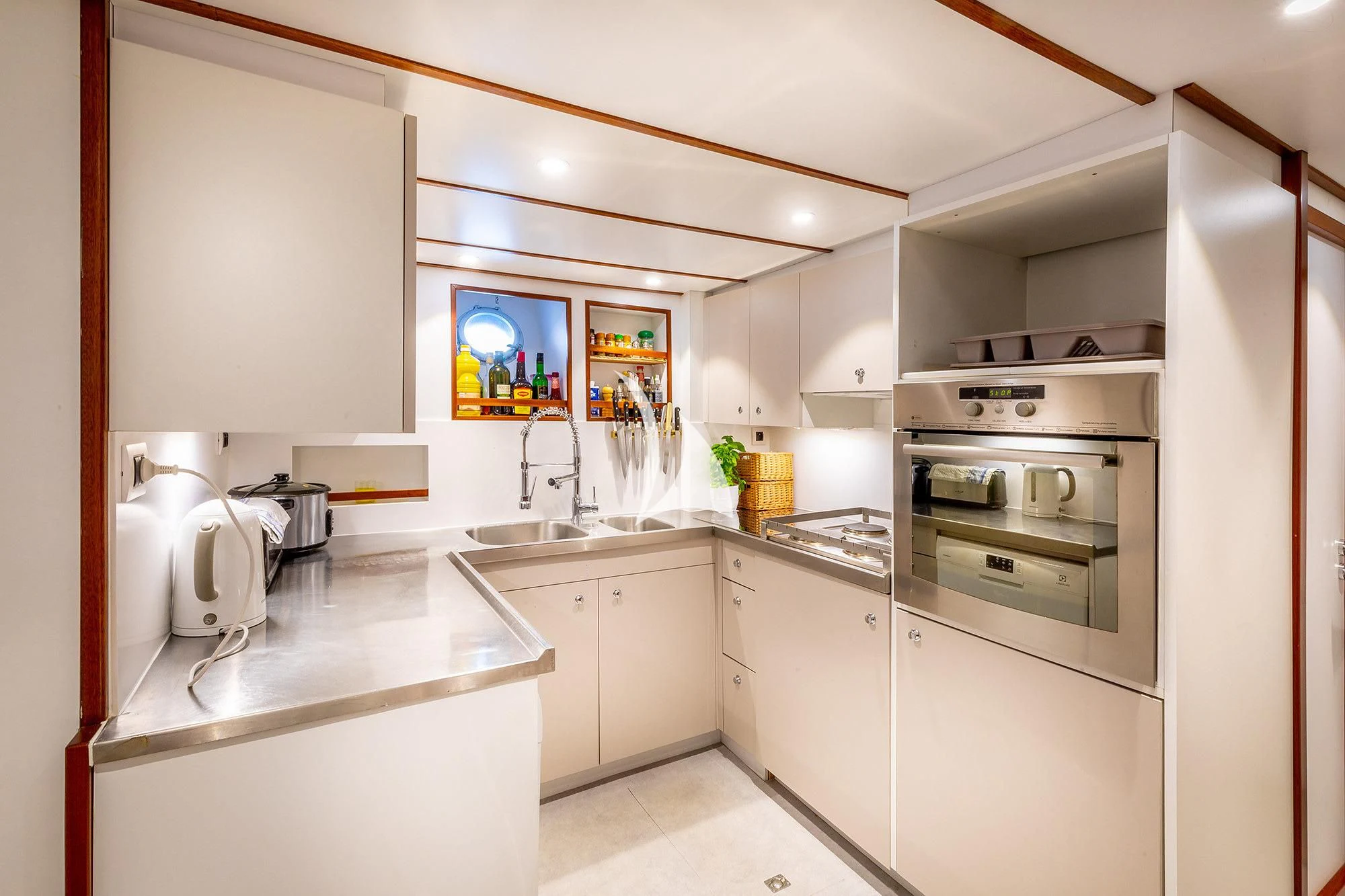 a kitchen with white cabinets aboard CHANTELLA Yacht for Sale