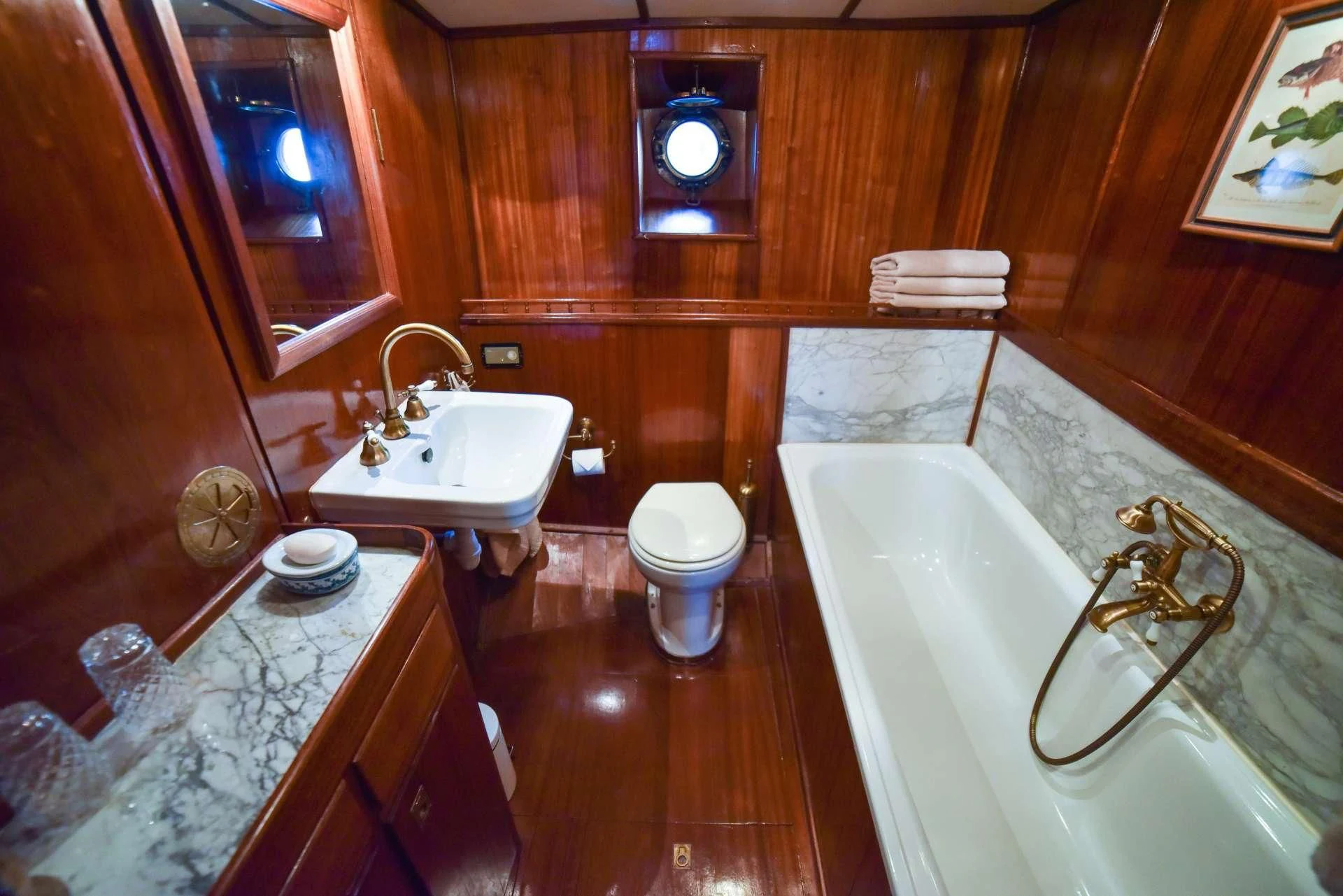 a bathroom with a tub sink and toilet aboard ENTRANCER Yacht for Sale
