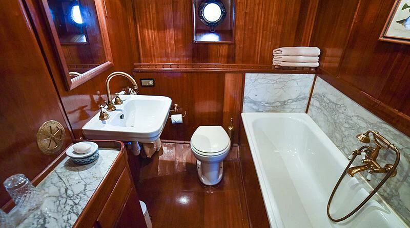 a bathroom with a tub sink toilet and a sink aboard ENTRANCER Yacht for Sale