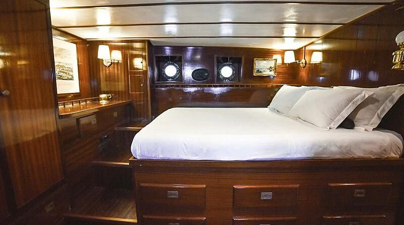 a bed with white sheets aboard ENTRANCER Yacht for Sale