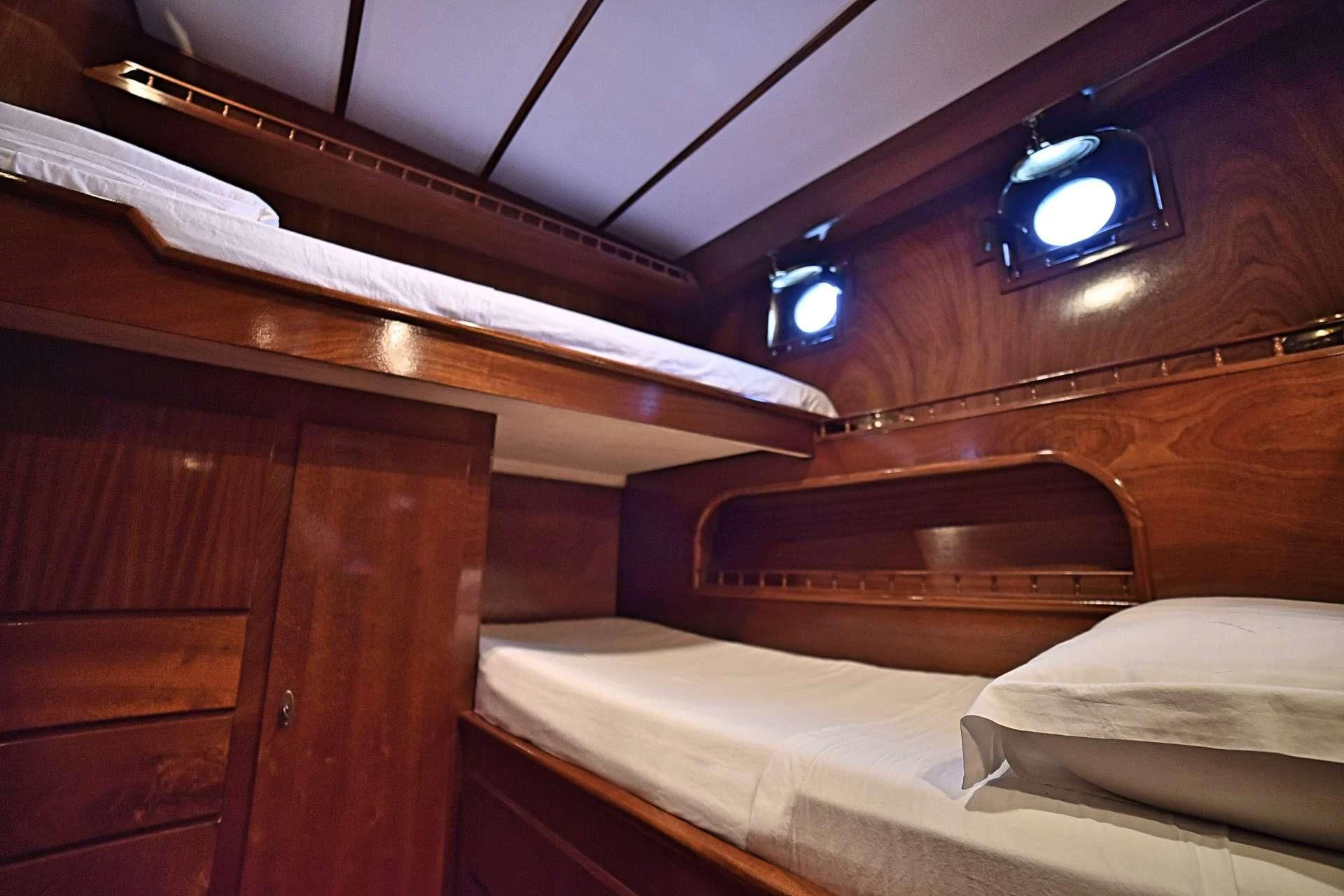 a room with a bed and a nightlight aboard ENTRANCER Yacht for Sale