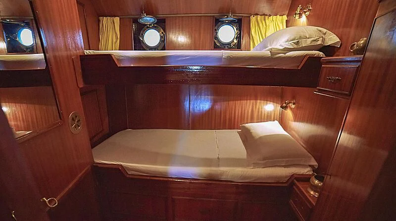 a room with a bed and a mirror aboard ENTRANCER Yacht for Sale