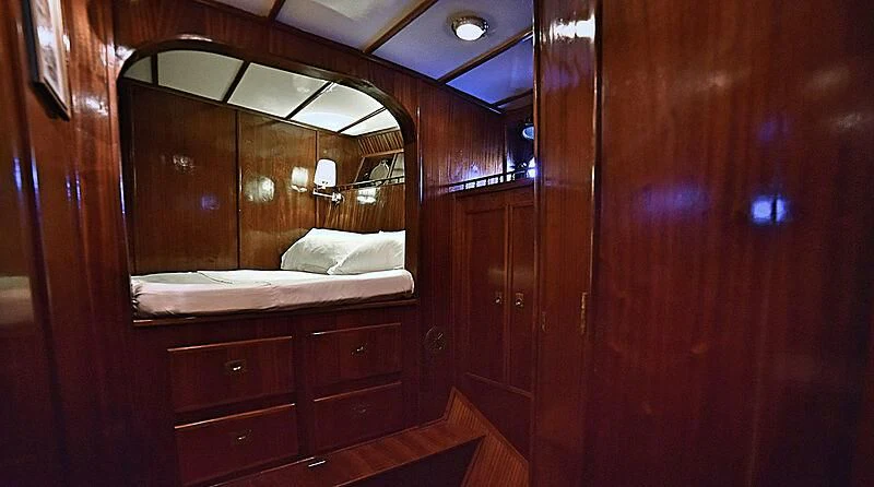 a room with a bed and a mirror aboard ENTRANCER Yacht for Sale