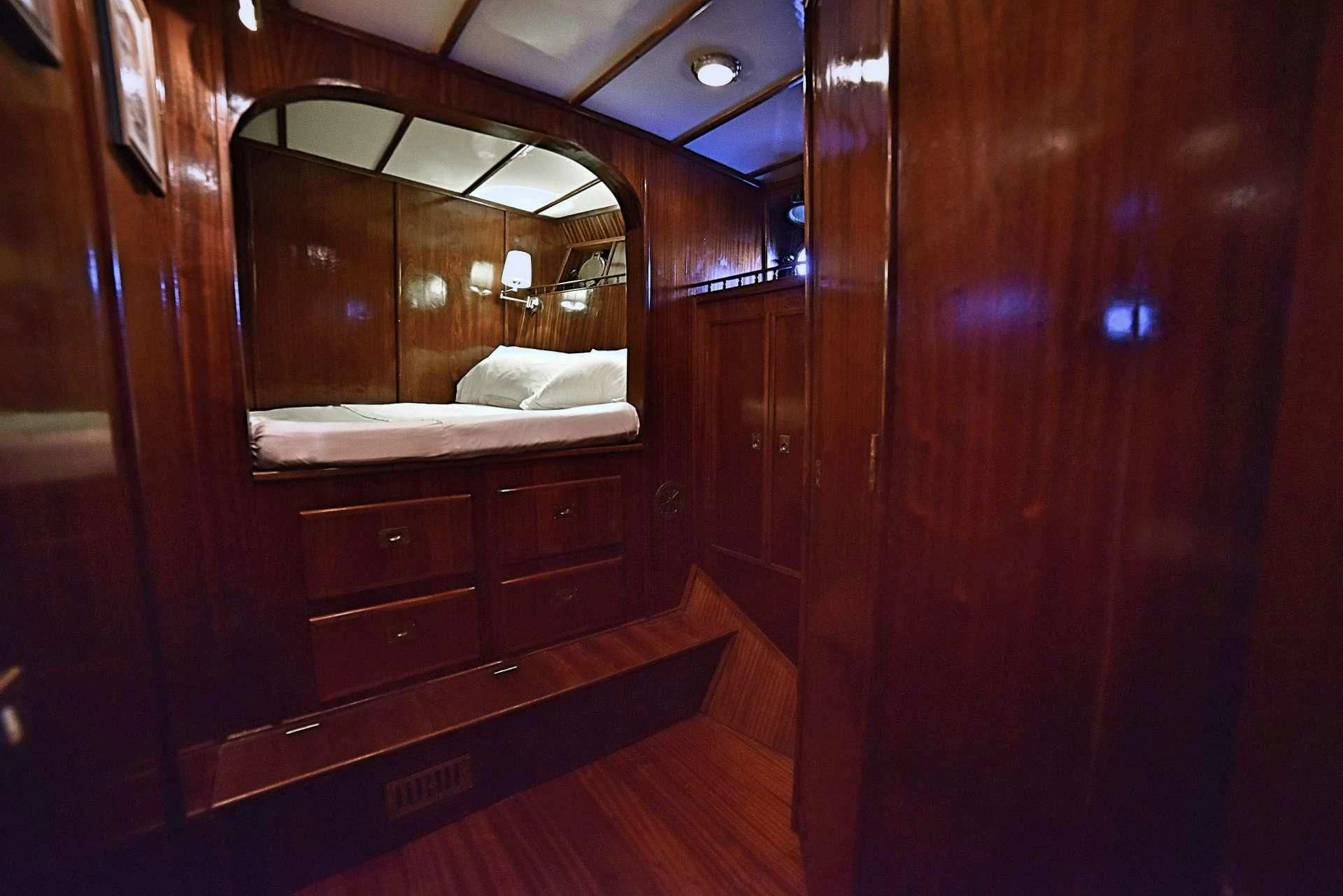 a room with a bed and a mirror aboard ENTRANCER Yacht for Sale