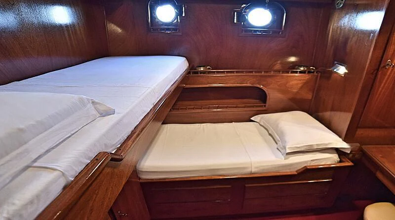a room with two beds aboard ENTRANCER Yacht for Sale
