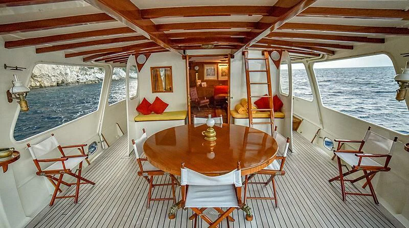 a boat with a table and chairs aboard ENTRANCER Yacht for Sale