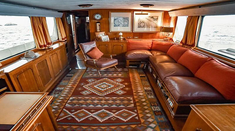 a living room with leather couches aboard ENTRANCER Yacht for Sale