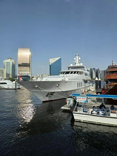 a large white boat in a harbor aboard OCEAN QUEEN Yacht for Sale