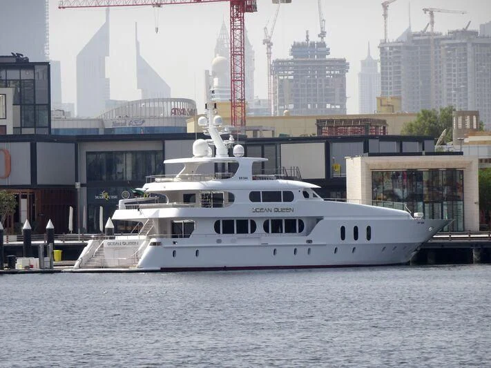 a large white boat in a harbor aboard OCEAN QUEEN Yacht for Sale