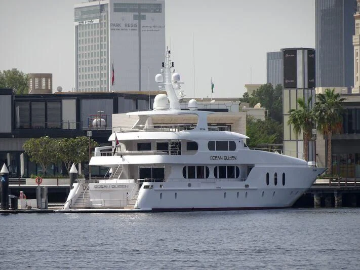 a large white boat in a harbor aboard OCEAN QUEEN Yacht for Sale