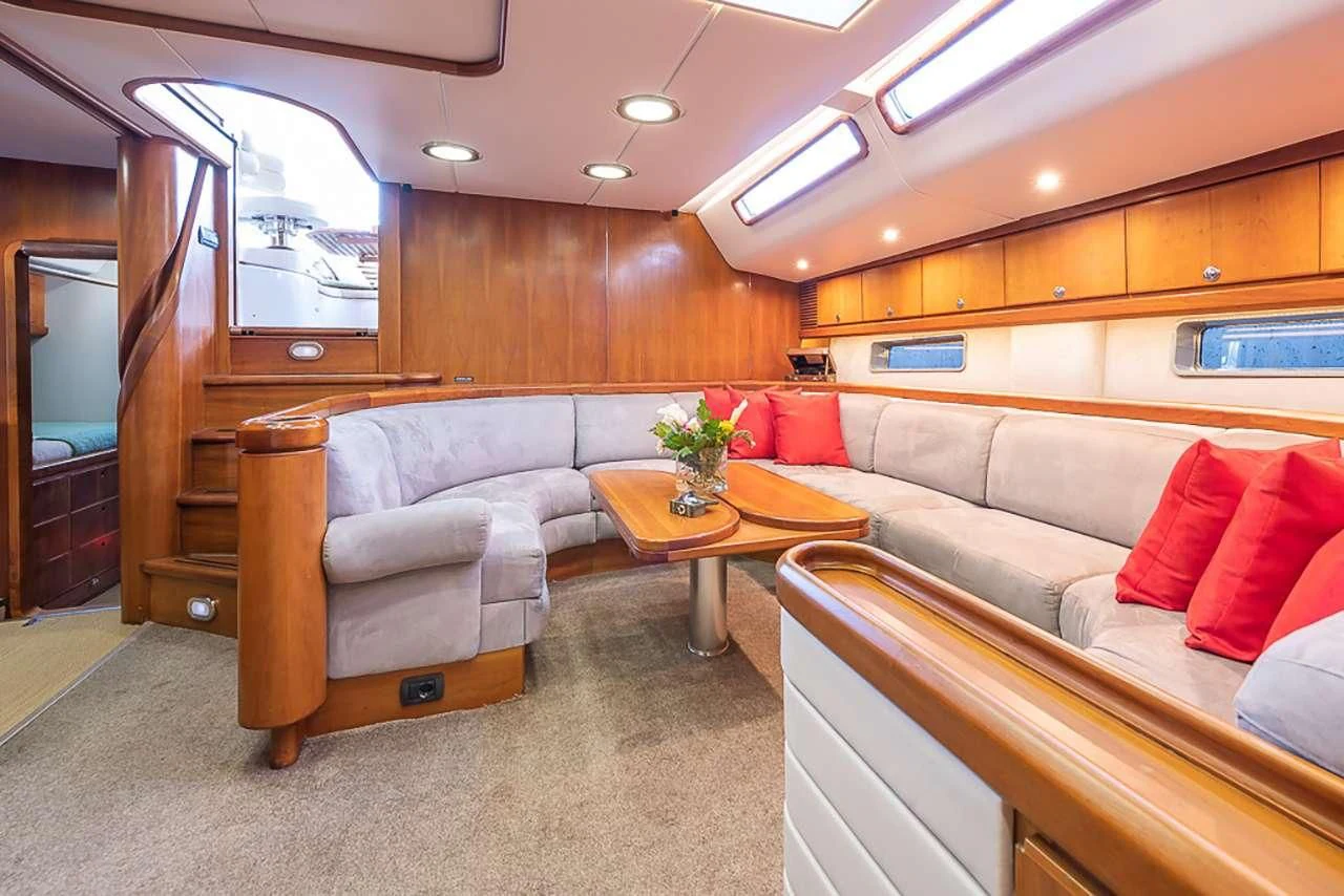 a living room with a couch and a coffee table aboard OCEAN PHOENIX Yacht for Sale