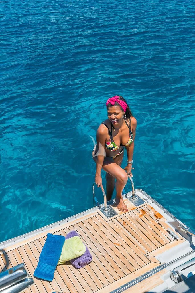 a woman in a bikini on a boat aboard OCEAN PHOENIX Yacht for Sale