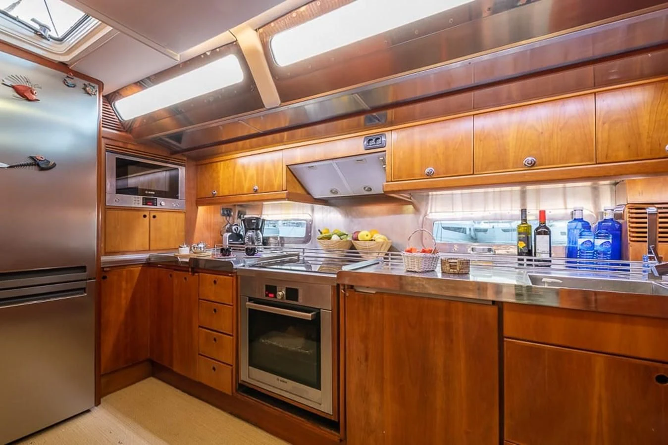 a kitchen with wooden cabinets aboard OCEAN PHOENIX Yacht for Sale