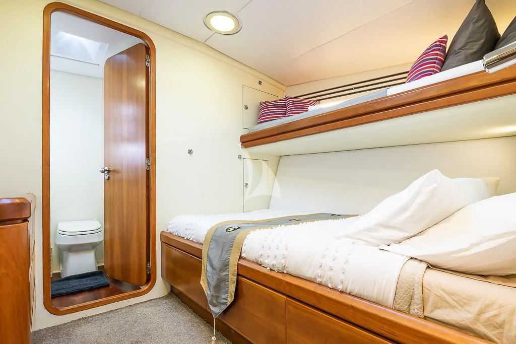a bedroom with a bed and a closet aboard OCEAN PHOENIX Yacht for Sale