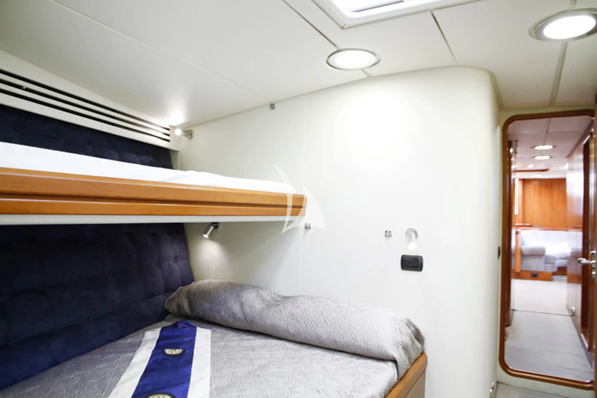 a room with a bed and a door aboard OCEAN PHOENIX Yacht for Sale