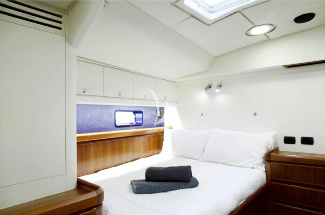 a room with a bed and a tv aboard OCEAN PHOENIX Yacht for Sale