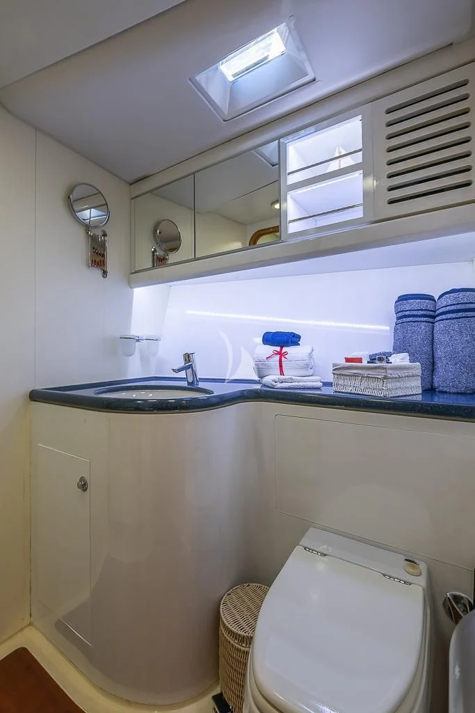 a bathroom with a sink and a toilet aboard OCEAN PHOENIX Yacht for Sale