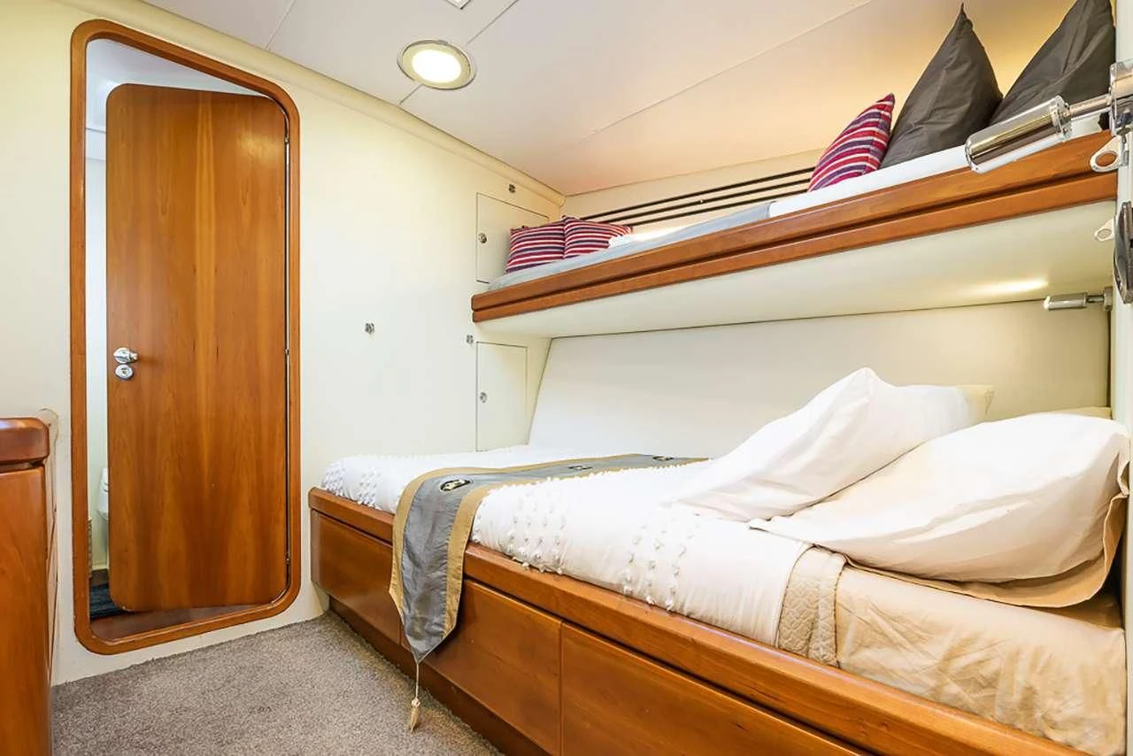 a room with two beds aboard OCEAN PHOENIX Yacht for Sale