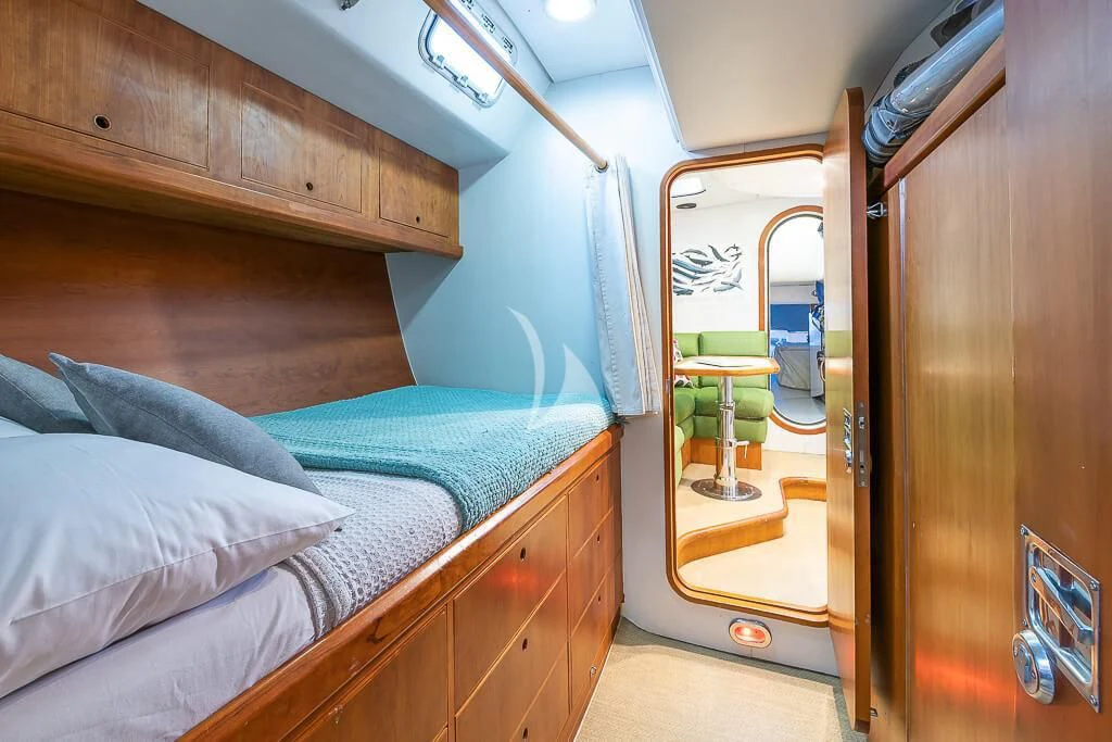 a bed with a mirror above it aboard OCEAN PHOENIX Yacht for Sale
