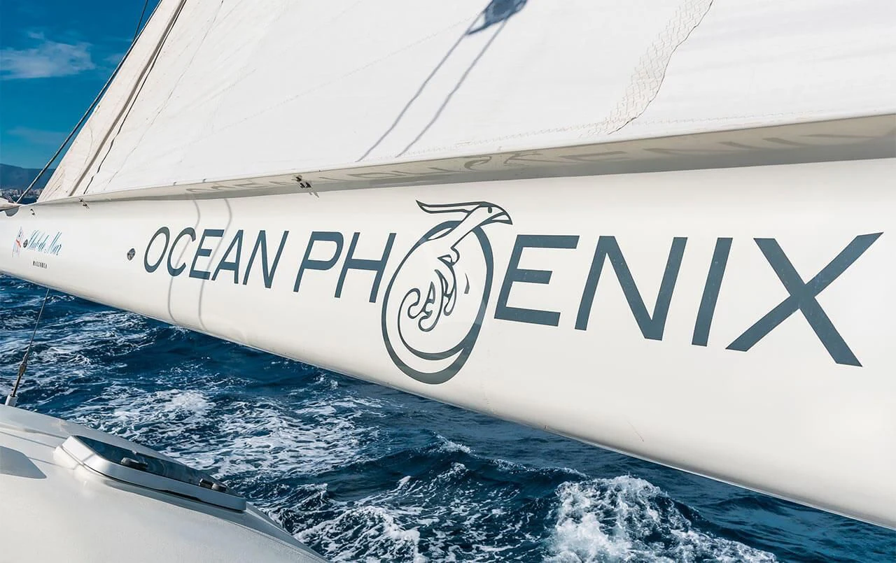 a white boat on the water aboard OCEAN PHOENIX Yacht for Sale