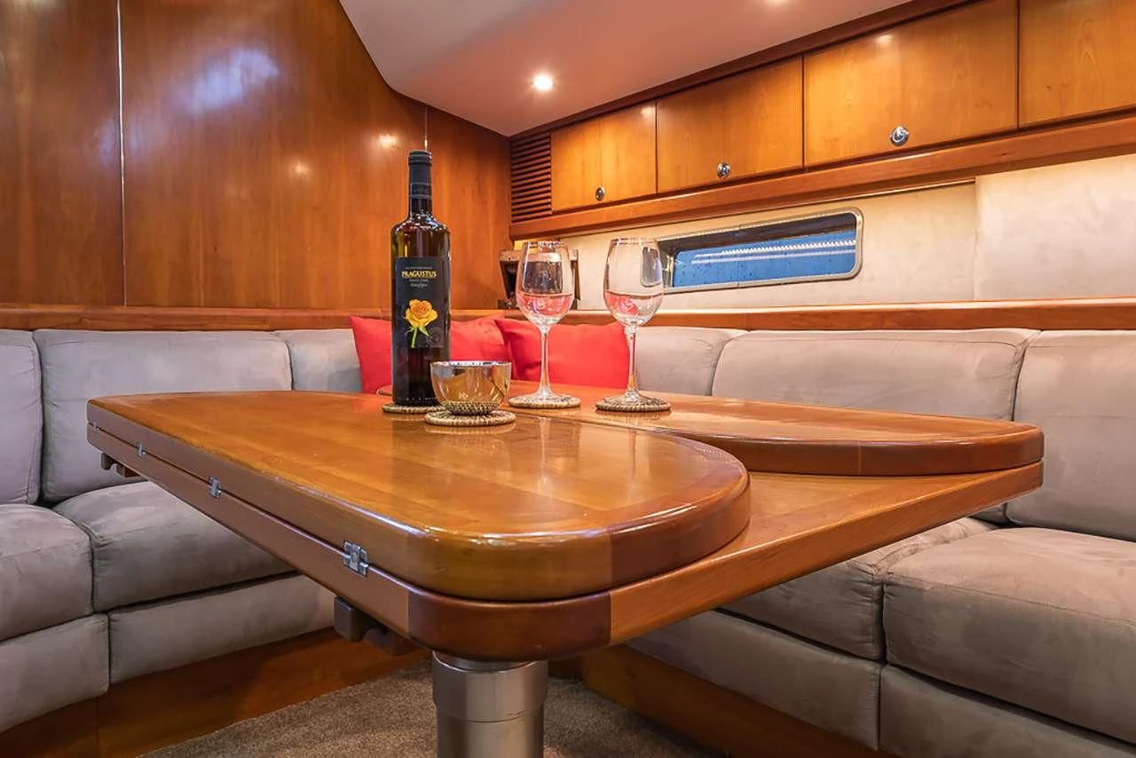 a table with wine glasses on it aboard OCEAN PHOENIX Yacht for Sale