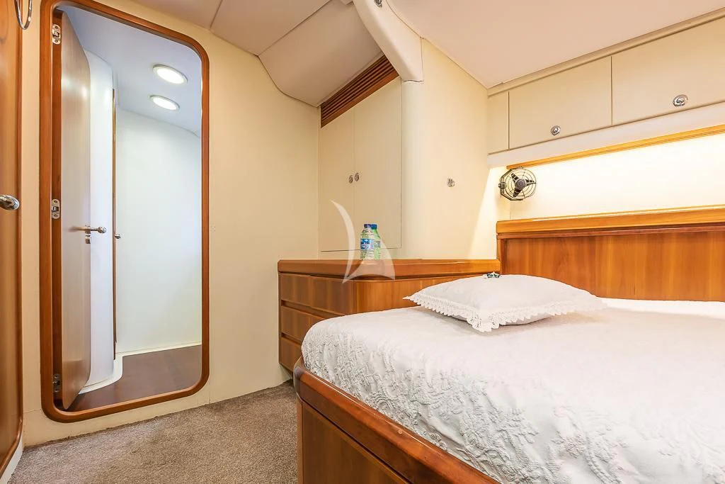 a bedroom with a large mirror aboard OCEAN PHOENIX Yacht for Sale