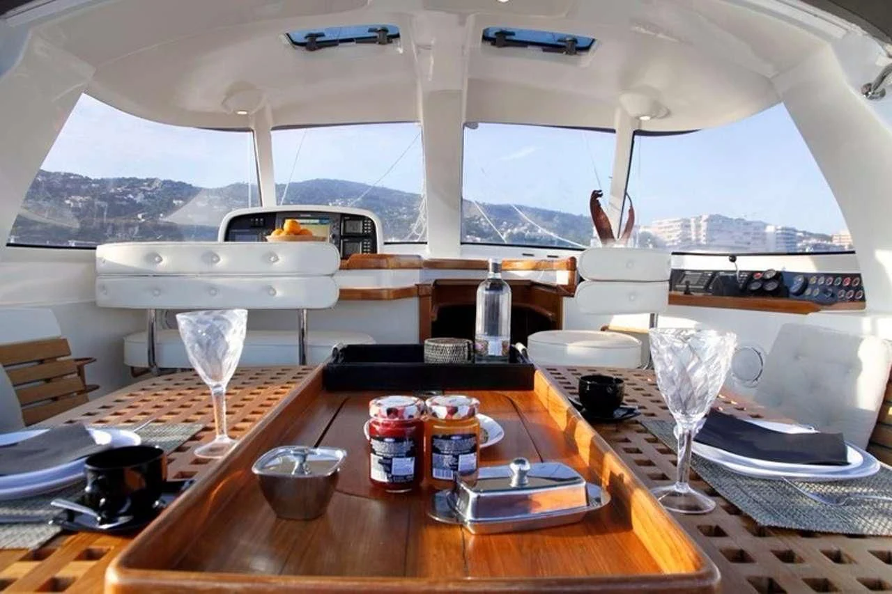 a table with plates and glasses aboard OCEAN PHOENIX Yacht for Sale