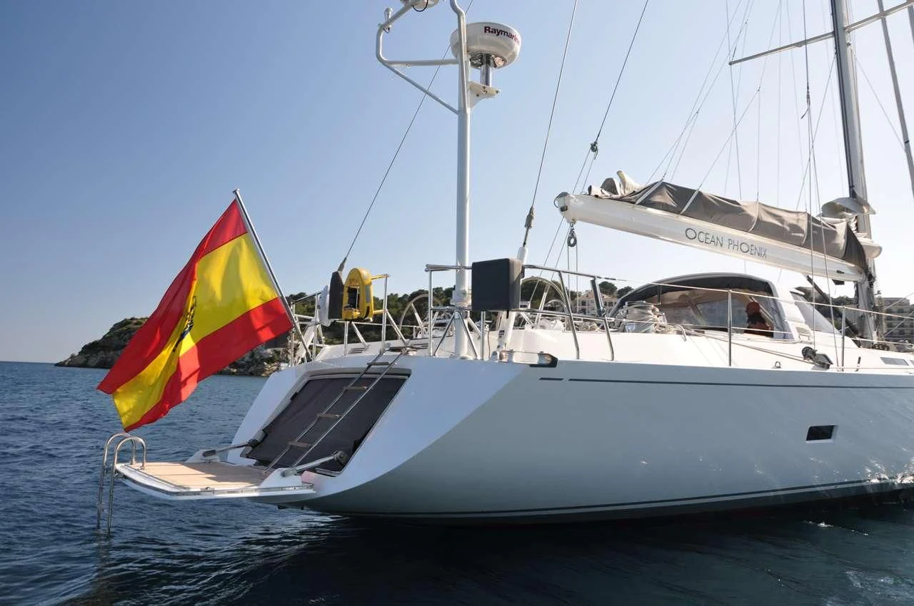 a boat with a flag on it aboard OCEAN PHOENIX Yacht for Sale