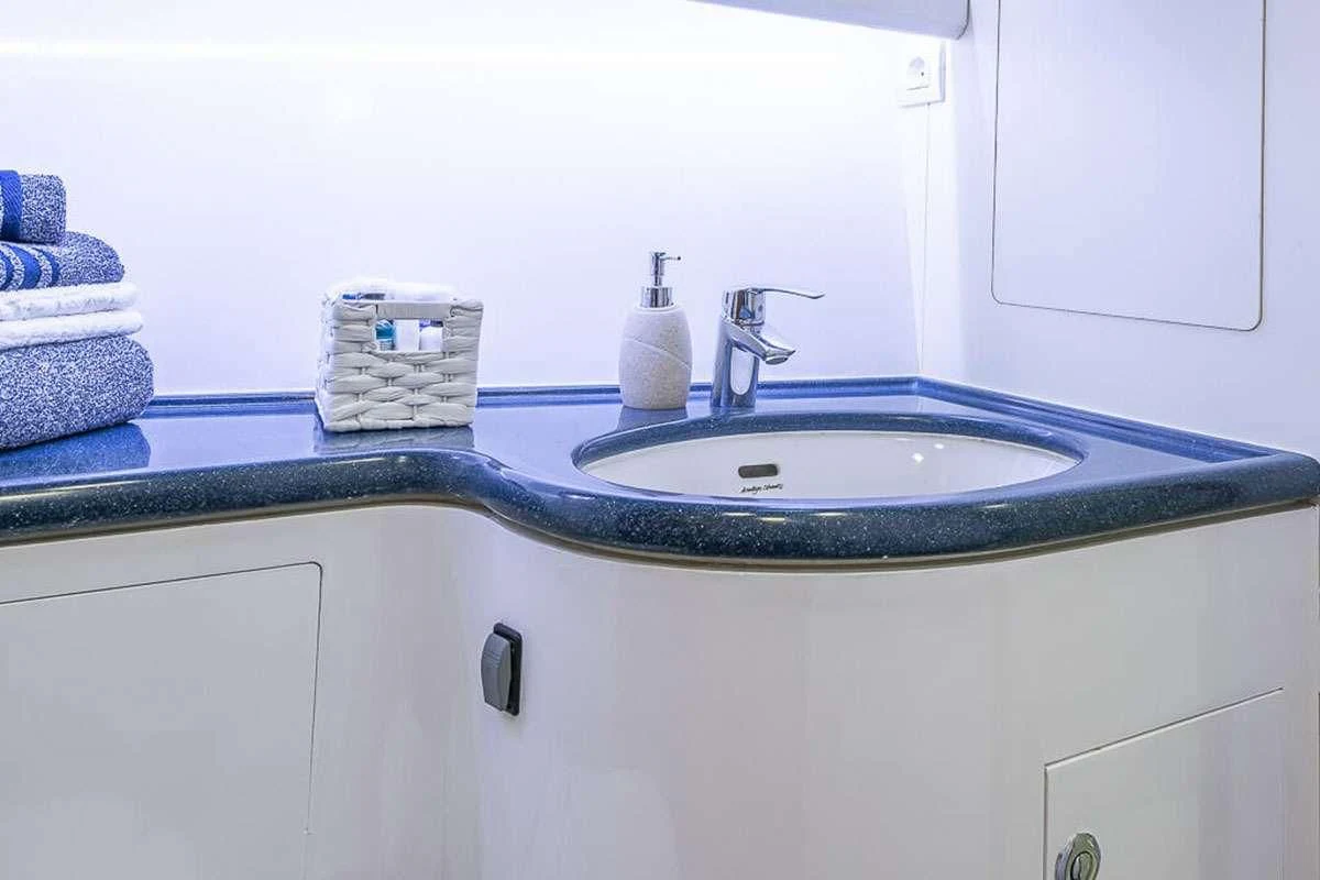 a bathroom sink with towels aboard OCEAN PHOENIX Yacht for Sale