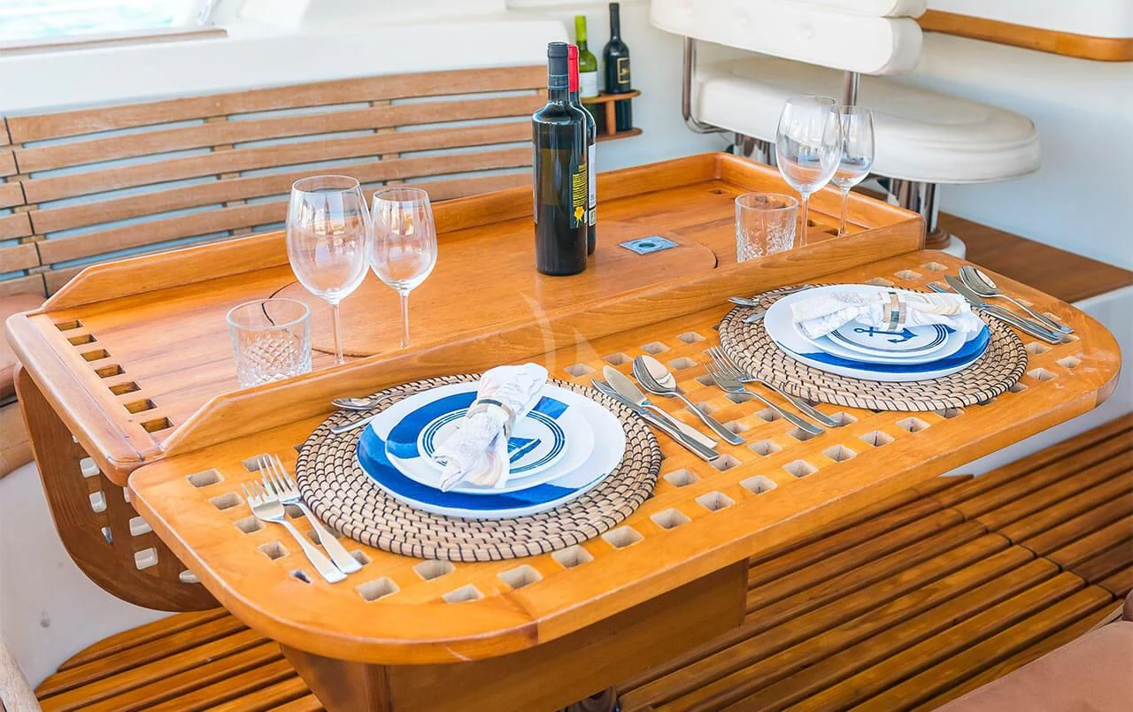 a table with plates and glasses on it aboard OCEAN PHOENIX Yacht for Sale