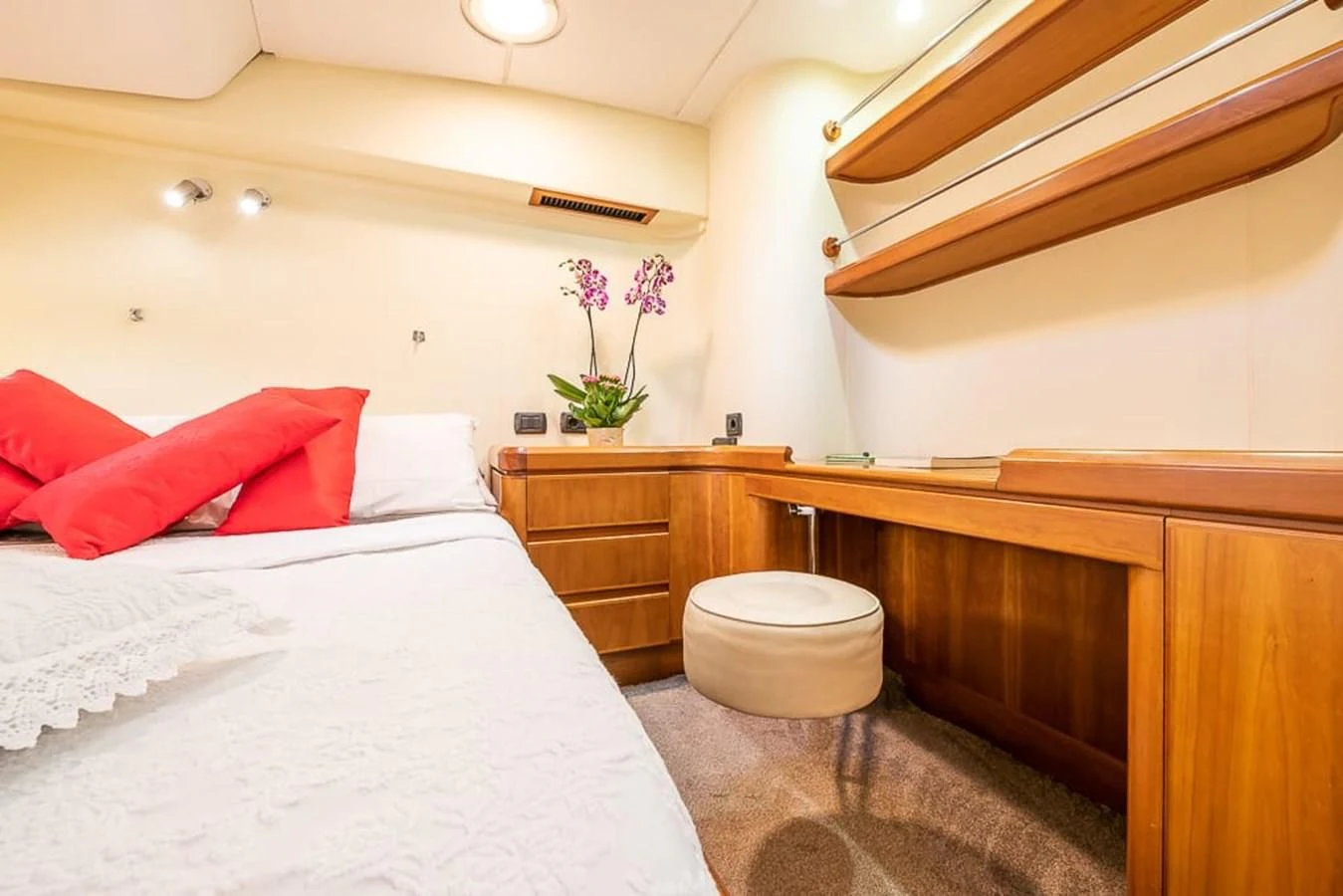a bed with pink pillows aboard OCEAN PHOENIX Yacht for Sale