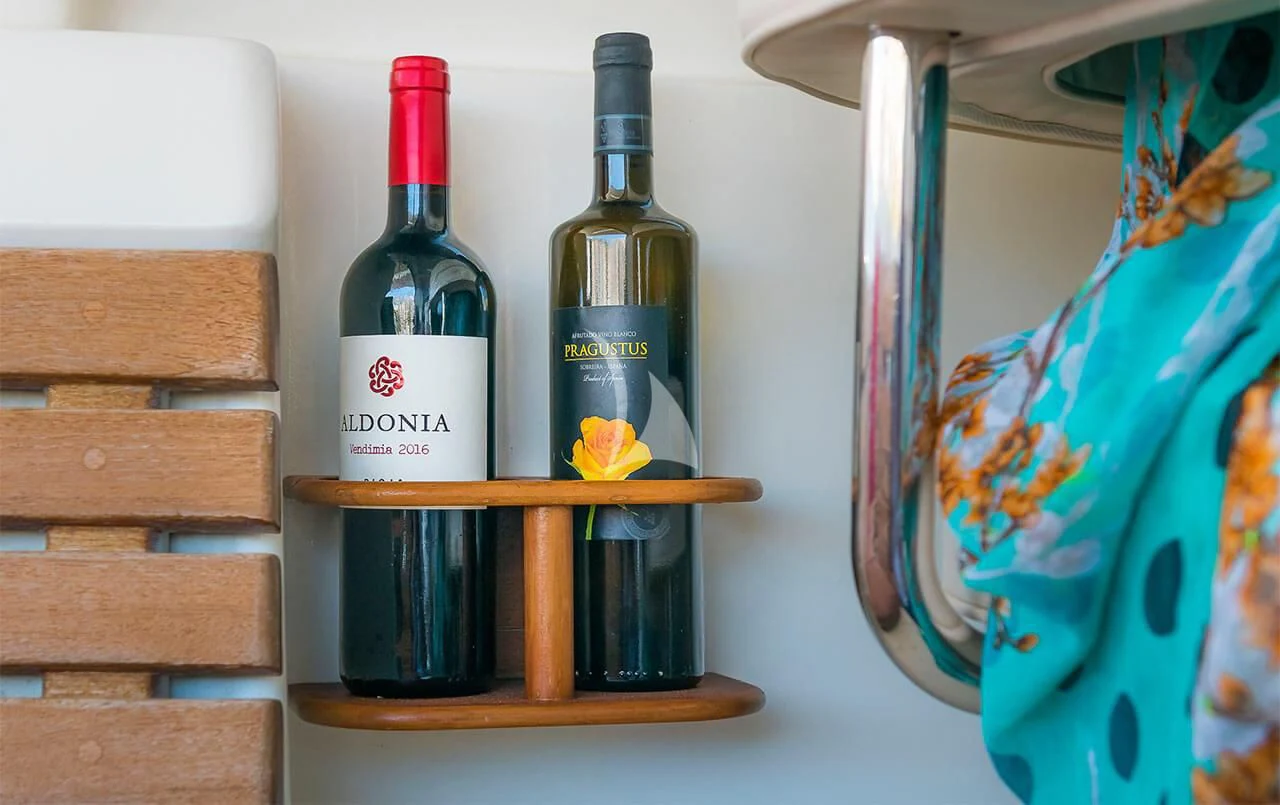 a bottle of wine and a box aboard OCEAN PHOENIX Yacht for Sale