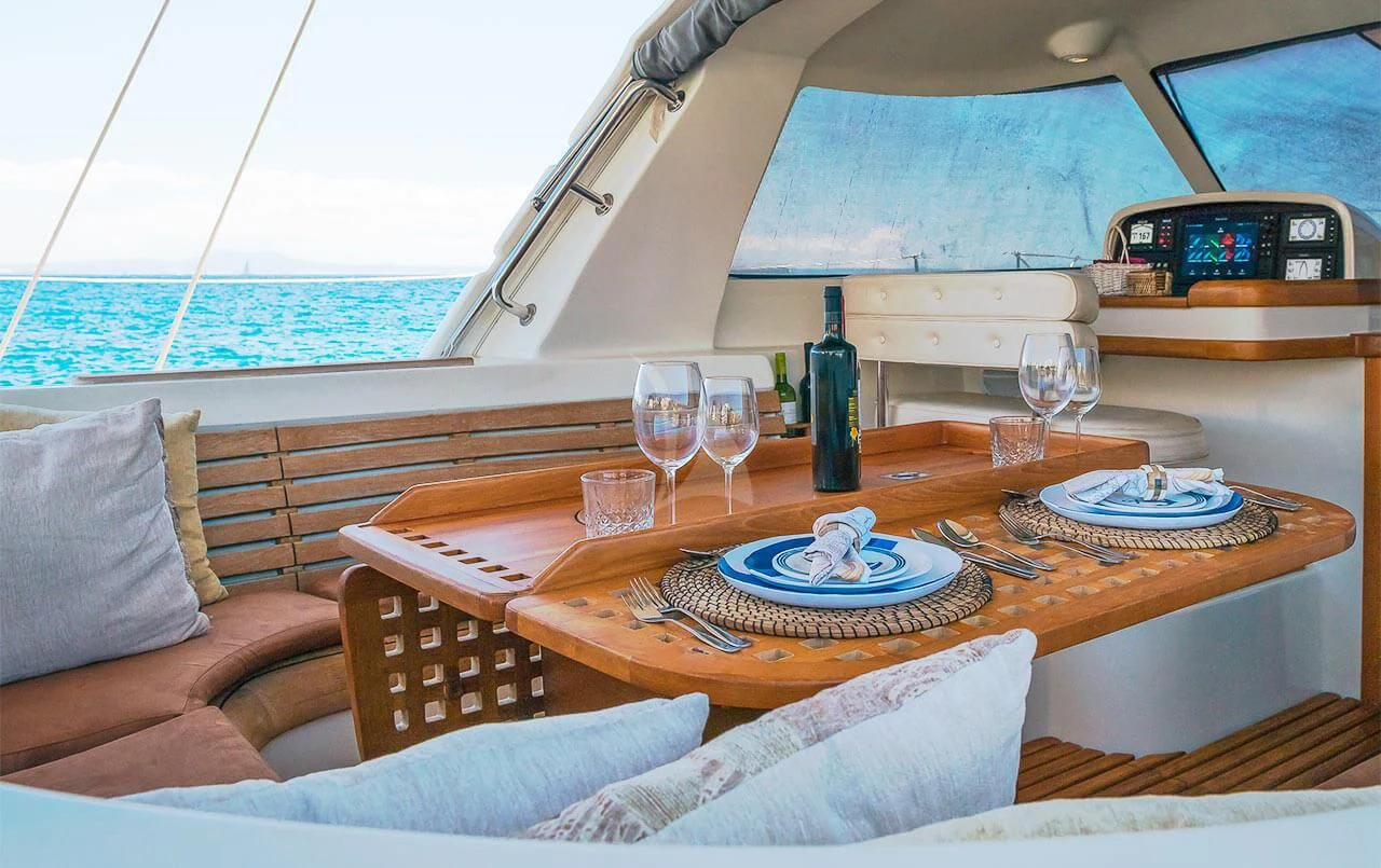 a table with plates and glasses on it aboard OCEAN PHOENIX Yacht for Sale
