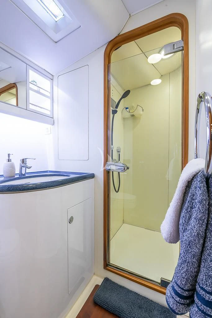 a bathroom with a large mirror aboard OCEAN PHOENIX Yacht for Sale