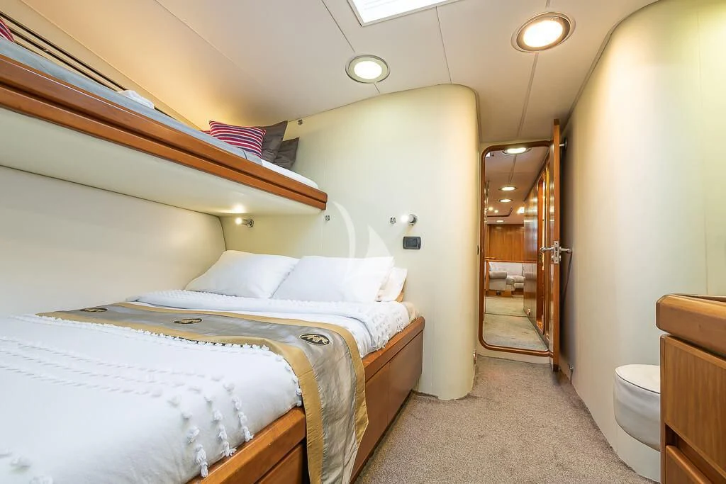 a bedroom with a bed and a door aboard OCEAN PHOENIX Yacht for Sale