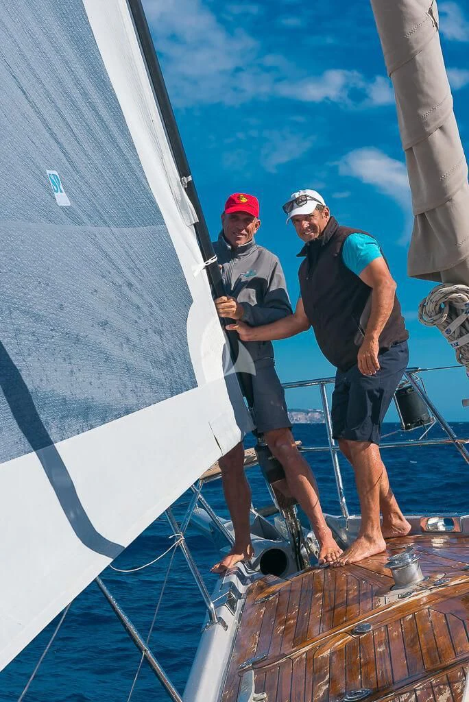 a couple of men on a sailboat aboard OCEAN PHOENIX Yacht for Sale
