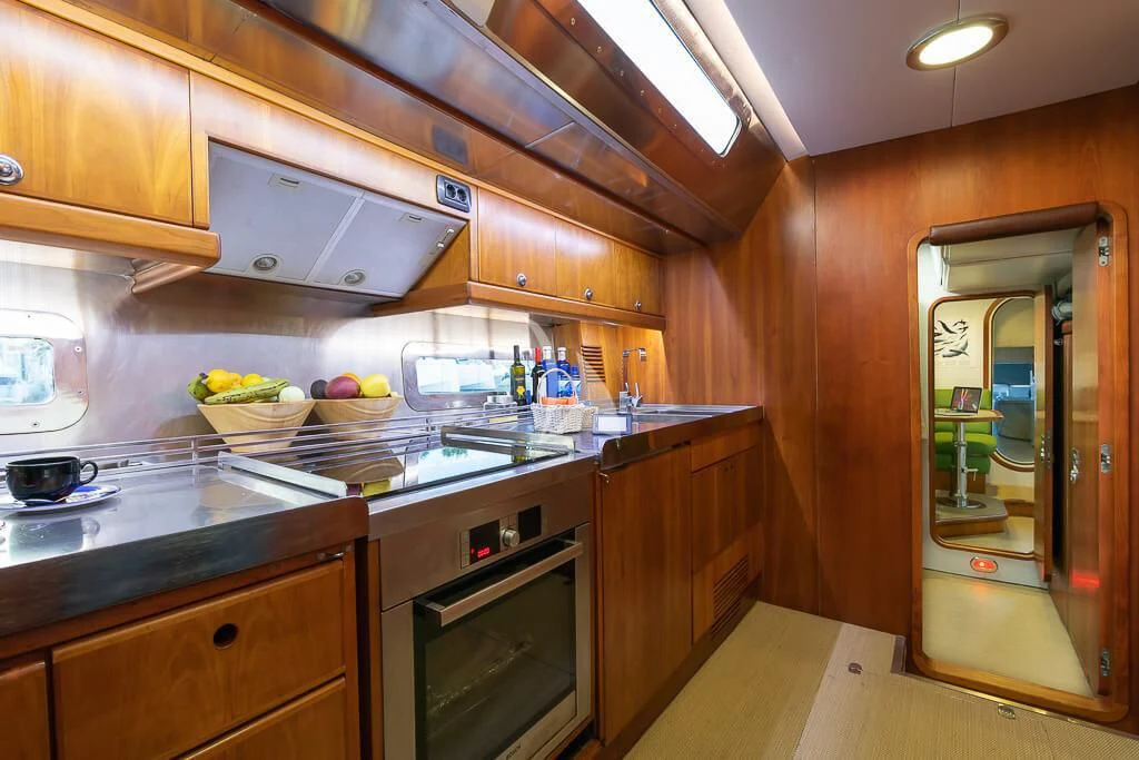 a kitchen with wooden cabinets aboard OCEAN PHOENIX Yacht for Sale