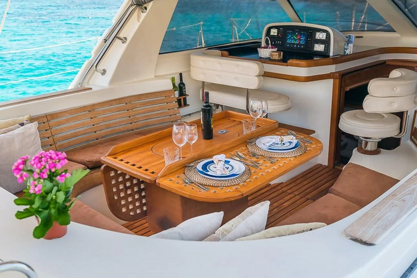 a table with wine glasses and a record player on it aboard OCEAN PHOENIX Yacht for Sale