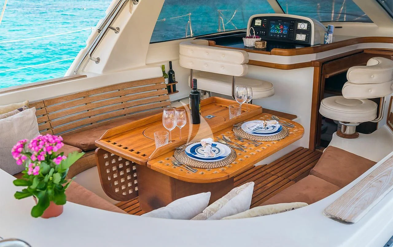 a table with wine glasses and a record player on it aboard OCEAN PHOENIX Yacht for Sale