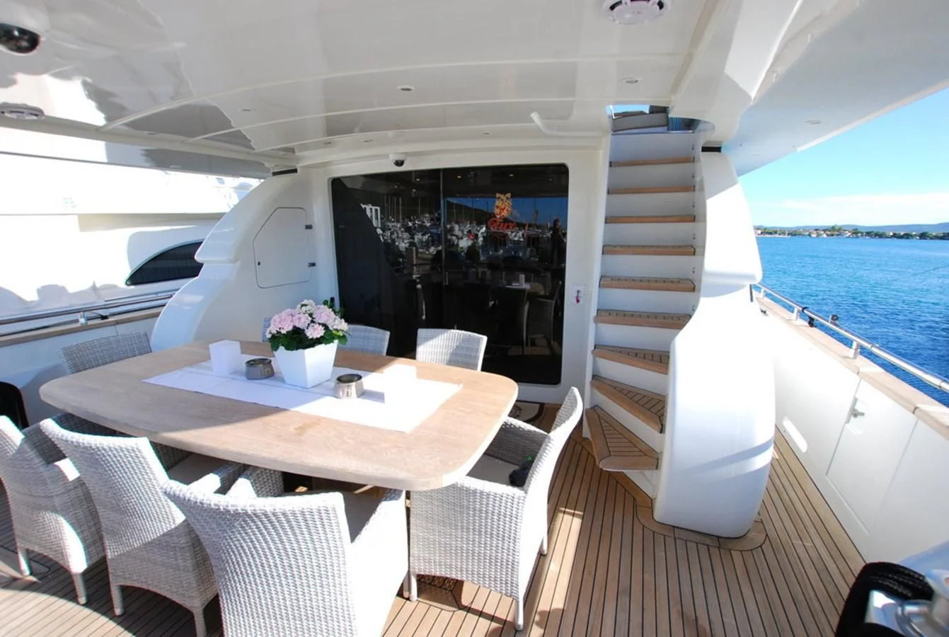 a table and chairs on a deck aboard COOKIE Yacht for Charter