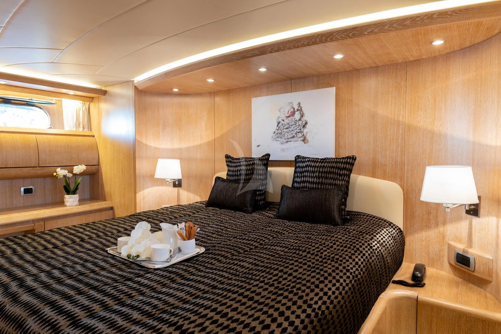 a bed with a black and white checkered blanket aboard COOKIE Yacht for Charter