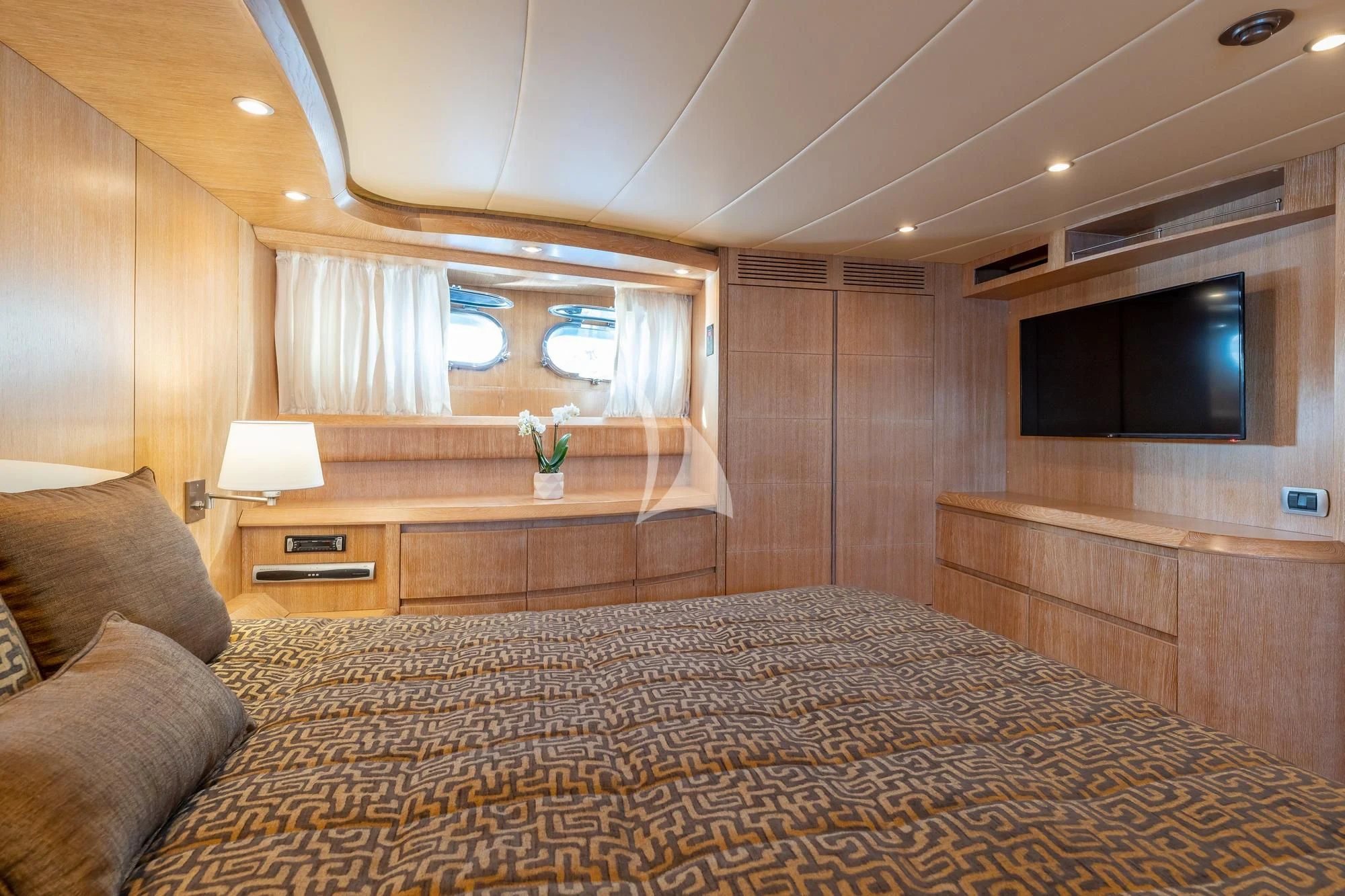a bedroom with a bed and a tv aboard COOKIE Yacht for Charter