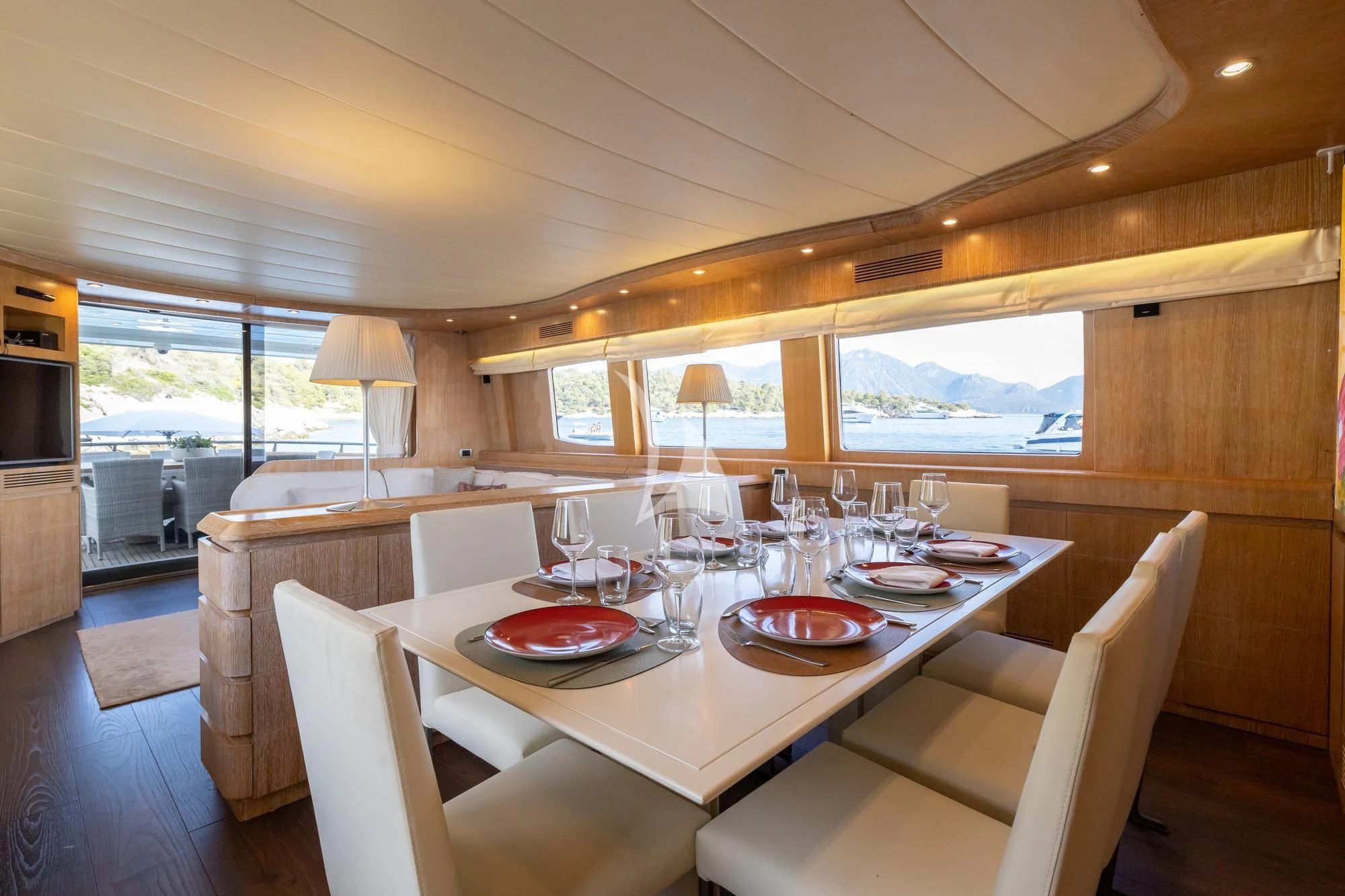 a dining table with plates and glasses aboard COOKIE Yacht for Charter