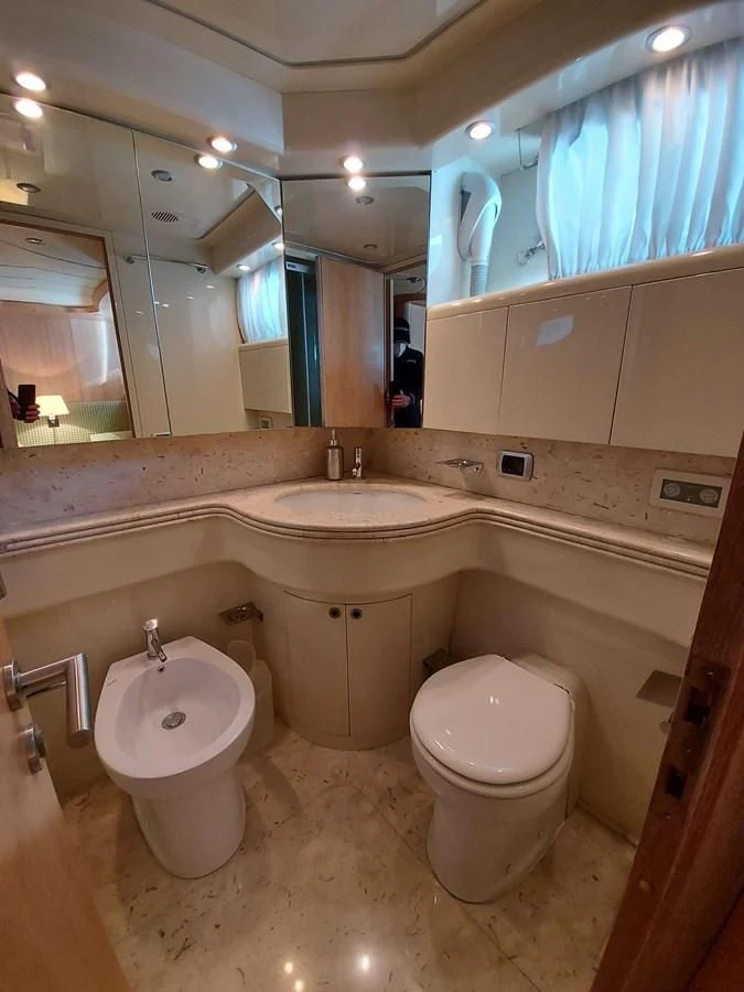 a bathroom with a sink toilet and a bidet aboard COOKIE Yacht for Charter