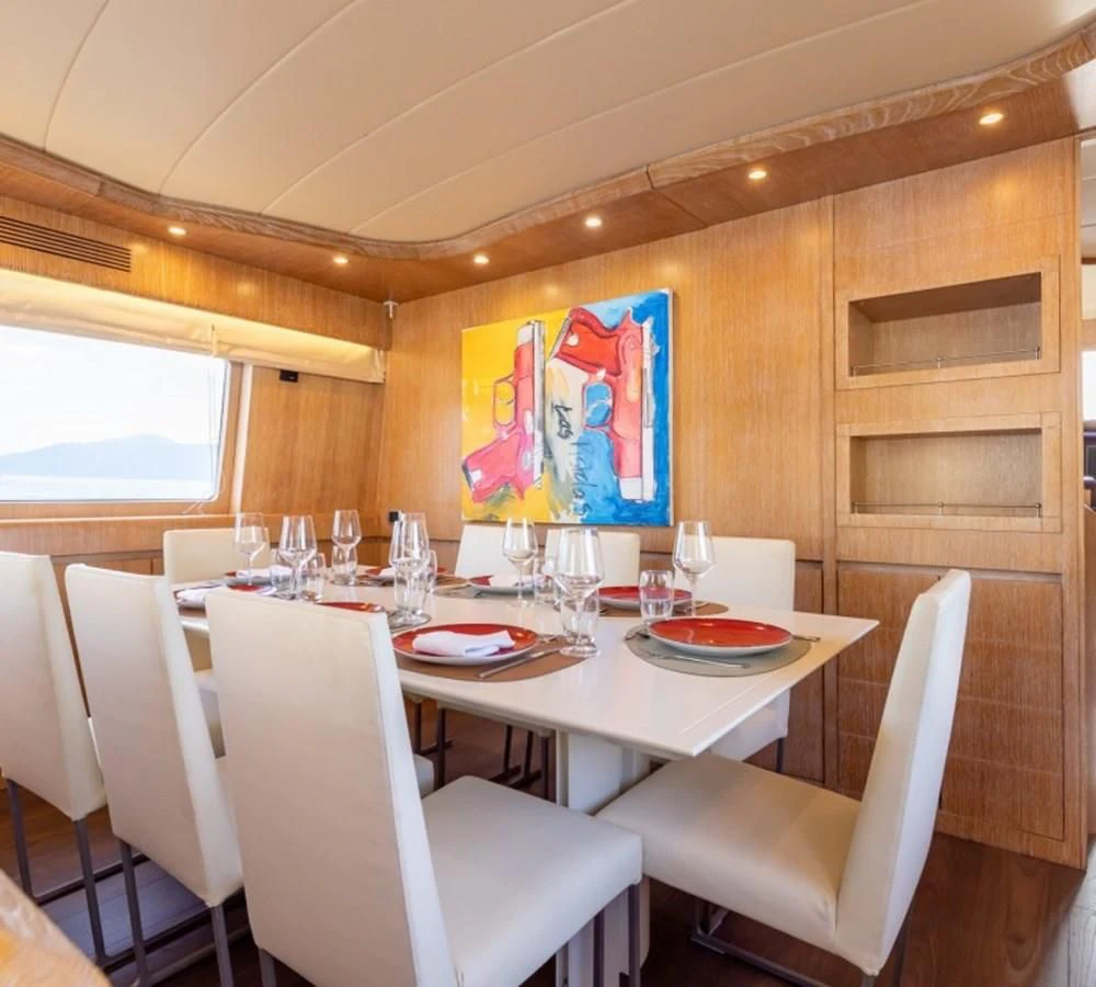 a dining table with a painting aboard COOKIE Yacht for Charter